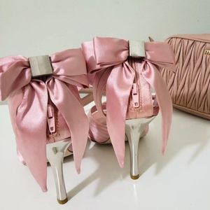 Pink heels with bow at the back. Size  5
